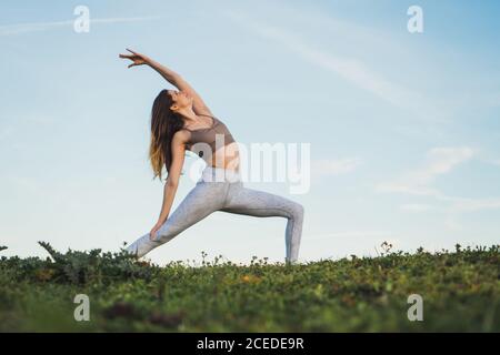 Femme faisant du yoga sur le terrain Banque D'Images