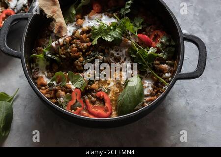 Bol près du pot avec ragoût de lentilles et patate douce curry Banque D'Images