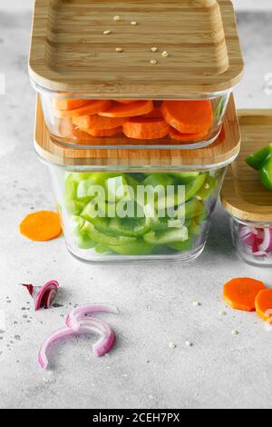 Boîtes en verre avec légumes frais crus. Préparation de repas sains - photos de préparation de recettes. Plats végétariens sains dans des récipients en verre. Perte de poids conce alimentaire Banque D'Images