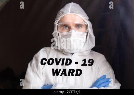 Homme en costume de protection et en masque médical de protection montrant un geste d'arrêt. Portrait d'épidémiologiste. Arrêter le coronavirus ou le covid-19 et la pandémie Banque D'Images