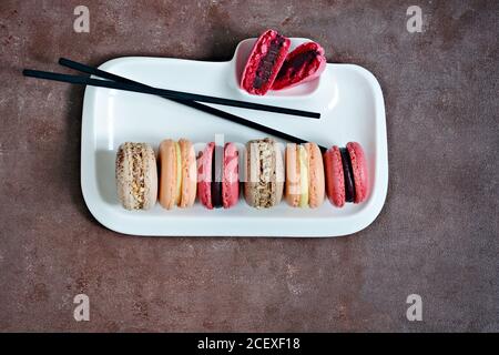 Gâteaux de macarons assortis français sur un plat rectangulaire. Petits gâteaux français colorés. Vue de dessus. Banque D'Images