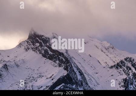 Pics de montagne pointus partiellement couverts de neige dans un cadre pittoresque et nuageux ciel en hiver Banque D'Images