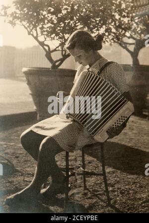 Fille inconnue avec l'accordéon (probablement à Florence, Italie, début des années 50) Banque D'Images