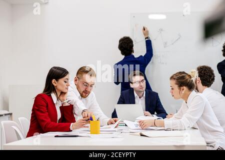une équipe d'affaires amicale crée un nouveau projet d'affaires ou une nouvelle stratégie de travail au bureau, portant des vêtements formels, des gens intelligents travaillent ensemble Banque D'Images