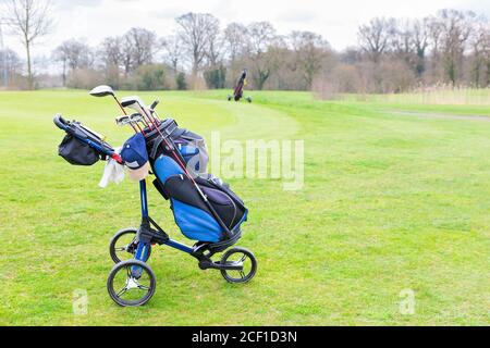 Chariot de golf situé sur un parcours de golf européen vert Banque D'Images