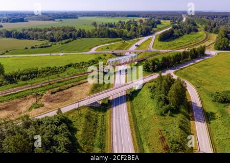 Vue aérienne de dessus de l'intersection à plusieurs niveaux de l'autoroute nationale lettone A1 (partie de la route européenne E67 - via Baltica) près de Skulte, Lettonie Banque D'Images