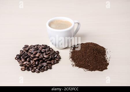 Une tasse de café ou une tasse de café avec des grains et du café moulu sur un bureau ou une table en bois, j'aime, le café, gros plan, le concept de fabrication du café Banque D'Images