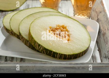 Melon piel de Sapo mûr, coupé en tranches fraîches sur un vaisselle en gros plan Banque D'Images