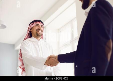 Poignée de main d'hommes d'affaires arabes et européens au bureau. Banque D'Images