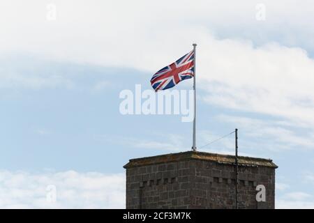 Drapeau Union Jack volant de la tour de l'église St Mary's, Hugh Town, St Mary's, Isles of Scilly Banque D'Images