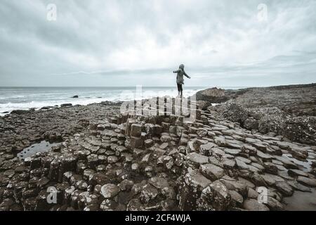Femme debout sur la falaise et contemplant Banque D'Images