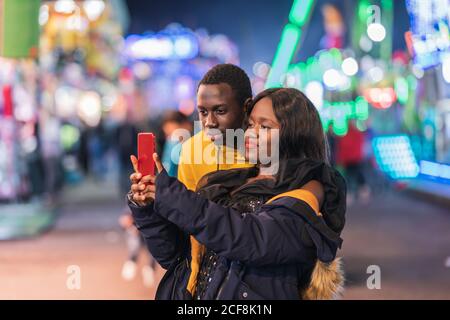 Couple noir prenant le selfie sur le champ de foire Banque D'Images