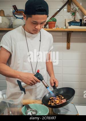 Ingrédients concentrés pour la friture de jeunes hommes pour la vaisselle japonaise appelée ramen Dans un restaurant asiatique Banque D'Images