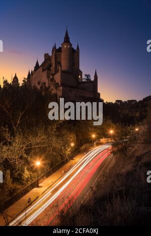 Depuis le dessus de l'ancienne forteresse entourée d'arbres et lumineux autoroute contre ciel étoilé la nuit Banque D'Images