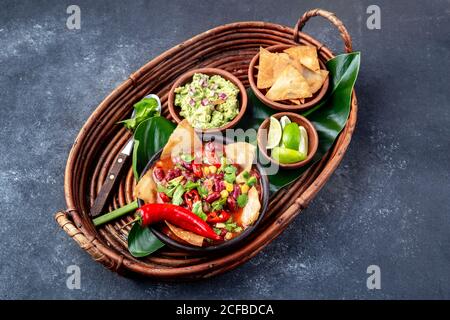 Soupe mexicaine aux haricots noirs avec tortillas totototopos nachos frits maison servi avec guacamole Banque D'Images