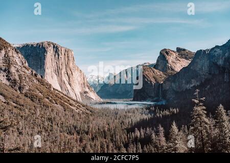 Paysage spectaculaire de Yosemite Valley avec lac entouré de forêt et des montagnes rocheuses sous ciel bleu ciel nuageux au printemps ensoleillé Journée en Californie Banque D'Images