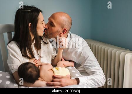 Des parents heureux qui allaitent bébé Banque D'Images