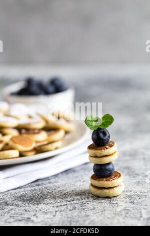 Petites crêpes pour le petit déjeuner. Mini crêpes sur une brochette avec myrtilles. Mise au point sélective Banque D'Images