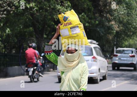 Dehradun, Uttarakhand/India - août 01 2020:UNE fille portant des aliments sur sa tête. Banque D'Images