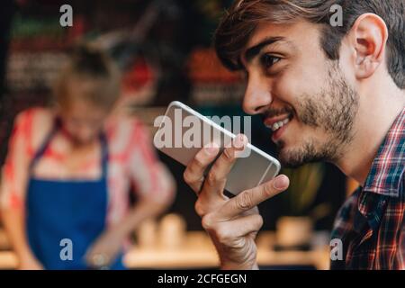 homme parlant à un téléphone dans un bar Banque D'Images