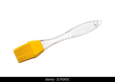 Brosse en silicone jaune avec poignée transparente Banque D'Images