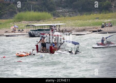 Lakeway, Texas États-Unis 5 septembre 2020 : un petit bateau de plaisance est partiellement submergé après avoir été submergé par de grandes vagues piétinées par des éréveil d'embarcations participant à une parade de bateaux pro-Donald Trump sur le lac Travis. Au total, cinq bateaux ont été submergés ou coulés pendant la fin de semaine de la fête du travail, qui a attiré des centaines de plaisanciers. Banque D'Images