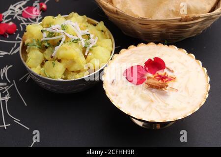 Puri/Bhaji et kheer - recette indienne semi-sèche de pommes de terre épicée également connue sous le nom de Batata ou Aloo ki Sabji, servie avec du poori frit et du khir Banque D'Images