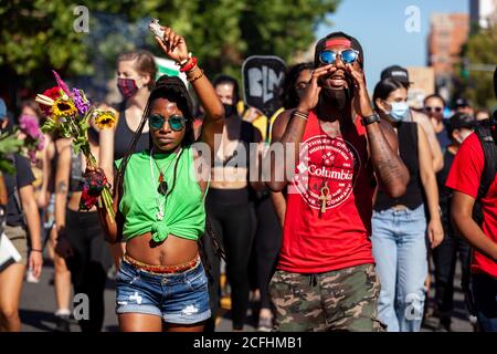 Washington, DC, Etats-Unis, 5 septembre 2020. En photo : deux membres des manifestations de DC marchent à l'avant de la Marche pour la Justice à la mémoire de Deon Kay, portant des fleurs et des sauge bourgeon. Deon Kay était un adolescent tué plus tôt dans la semaine par la police métropolitaine (DC). Le meurtre est controversé car la police a publié des comptes-rendus contradictoires du meurtre. Crédit : Allison C Bailey/Alamy Banque D'Images