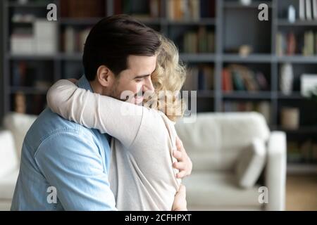 Gros plan jeune homme aimant embrassant la mère mature à la maison Banque D'Images