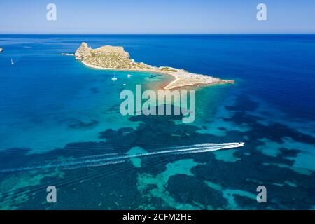 Vue aérienne des bateaux dans un océan bleu clair cristal à côté d'une petite île (Kolokitha, Crète, Grèce) Banque D'Images