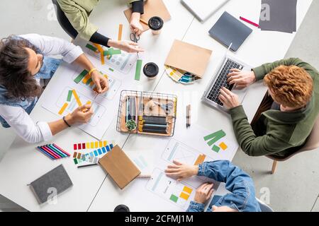 Vue de quatre concepteurs contemporains de nouvelles applications mobiles assis par table Banque D'Images