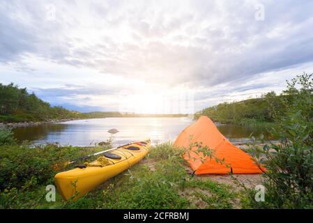 kayak et tente au bord du lac gris Banque D'Images