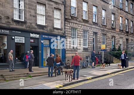 Les gens et leurs animaux font la queue et font des distances sociales en dehors d'une pratique vétérinaire à DundasStreet, Edimbourg, Écosse, Royaume-Uni. Banque D'Images