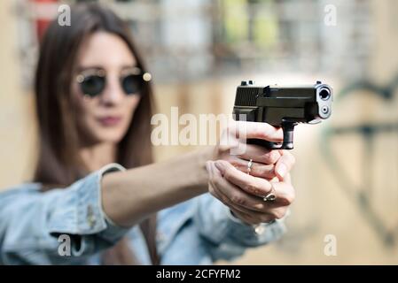 un instructeur de tir de fille prend le but avec un pistolet à la site Banque D'Images