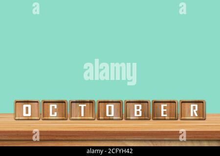 Blocs de l'alphabet d'octobre sur une table en bois avec fond bleu. Copier l'espace pour le texte Banque D'Images