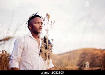 homme africain dans la brousse africaine avec chapeau de brousse l'herbe Banque D'Images