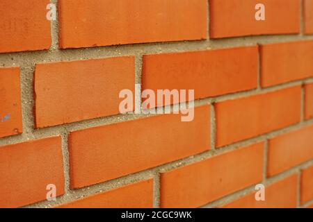 Mur de briques orange. Vue rapprochée en perspective Banque D'Images