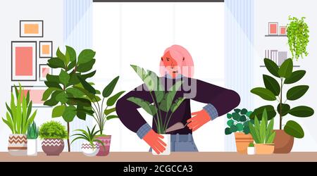 femme plantant des plantes de maison dans la marmite femme de soin de ses plantes illustration vectorielle horizontale portrait Illustration de Vecteur