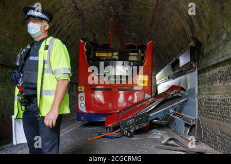 Headbourne worthy, Winchester, Royaume-Uni jeudi 10 septembre 2020. NOTE: Numberplate floue pour la sécurité UN policier se tient près de l'autobus scolaire de Stagecoach qui a eu son toit déchiré quand il s'est écrasé dans un pont de chemin de fer, blessant plusieurs enfants à Wellhouse Lane, Headbourne digne, près de Winchester, Royaume-Uni. Trois enfants ont été grièvement blessés par l'accident qui s'est produit le 8.12 jeudi matin alors que le bus emportait des élèves à l'école Henry Beaufort. Un certain nombre d'ambulanciers, d'pompiers et de policiers ont assisté à la scène. Luke MacGregor / Alamy Banque D'Images