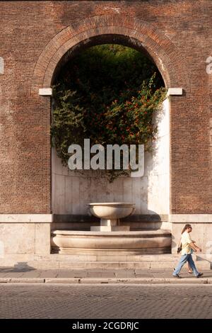 Rome, Italie - 27 juin 2010 : un couple touristique passe devant la fontaine des Forums impériaux, Rome. Banque D'Images