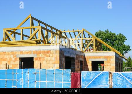 construction d'une nouvelle structure de toit de maison résidentielle sur un fond bleu ciel Banque D'Images