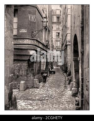 PARIS 1880 VUE SUR LA RUE DE Glatigny Paris France par Charles Marville en regardant le long de la voie pavée avec plaque sur le mur et le panneau VINS en partant de la lecture à gauche : rue haute des Urpéchés, lanterne dans le coin du bâtiment, porte en arcades sur la droite. Date 1865 Banque D'Images