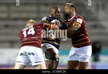 Robert Lui de Leeds Rhinos est affronté par le Matty English de Huddersfield Giants (à gauche) et par Kenny Edwards lors du match de la Super League de Betfred au stade totalement Wicked, St Helens. Banque D'Images