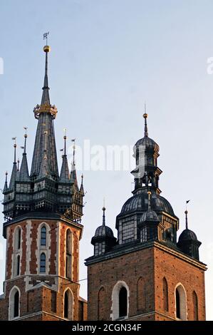 Haut des deux tours gothiques, la tour d'appel de bugle et le clocher, de la rue du 14th siècle Basilique Marie dans la vieille ville de Cracovie, Pologne en 2010. Banque D'Images