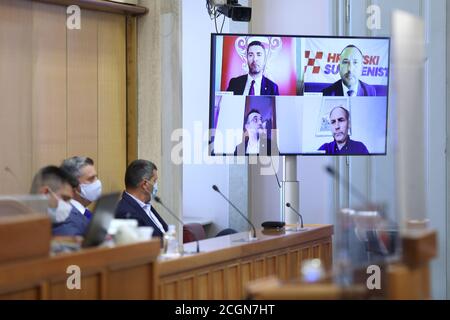 (200912) -- ZAGREB, le 12 septembre 2020 (Xinhua) -- quatre membres du Parlement croate, qui sont dans l'isolement après avoir été testés positifs pour le COVID-19, participent à un vote parlementaire par vidéo streaming à Zagreb, Croatie, le 11 septembre 2020. Vendredi, le Parlement croate a adopté une loi sur la reconstruction de la capitale Zagreb et de sa banlieue à la suite d'un tremblement de terre en mars. Au total, 124 députés ont voté pour le projet de loi, tandis que 10 se sont abstenus et quatre se sont opposés à la législature de 151 sièges. (Patrik Macek/Pixsell via Xinhua) Banque D'Images