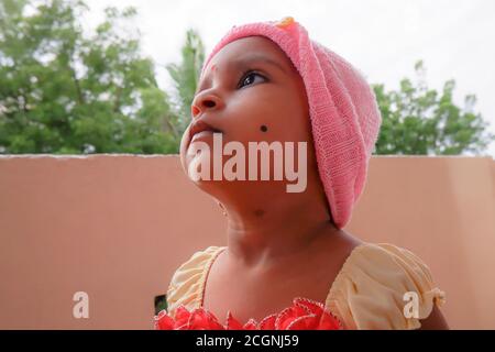 Kalaburagi, Karnataka/Inde-août, 22.2020: vue en gros plan de la casquette rose portant une fille indienne regardant côté Banque D'Images
