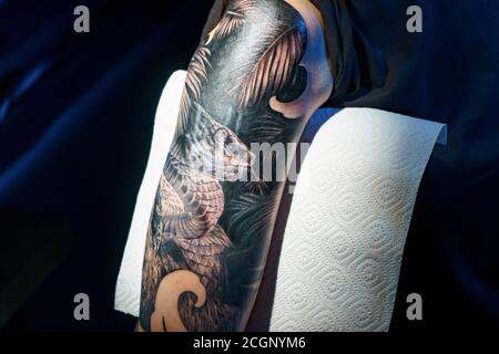 Photo de l'homme faisant tatouage noir de serpent pour la femme Banque D'Images