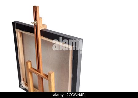 Toile en coton noir étirée sur le berceau et chevalet de table en bois, isolée sur fond blanc. Vue de l'arrière Banque D'Images