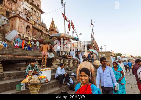 Varanasi, Uttar Pradesh, Inde : les gens s'assoient et marchent dans les ghats le long du Gange. Banque D'Images