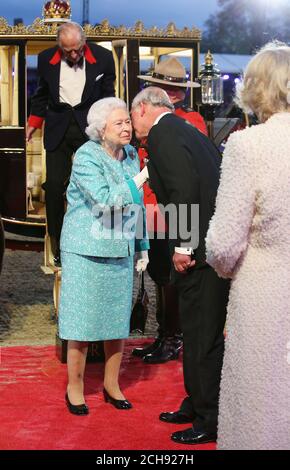 La reine Elizabeth II est accueillie par le prince de Galles alors qu'elle et le duc d'Édimbourg arrivent pour la célébration télévisée de son 90e anniversaire dans le domaine du château de Windsor dans le Berkshire. Banque D'Images